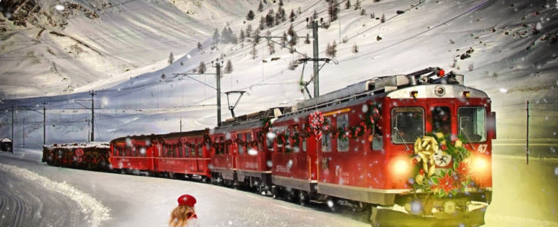 Train driving through snow